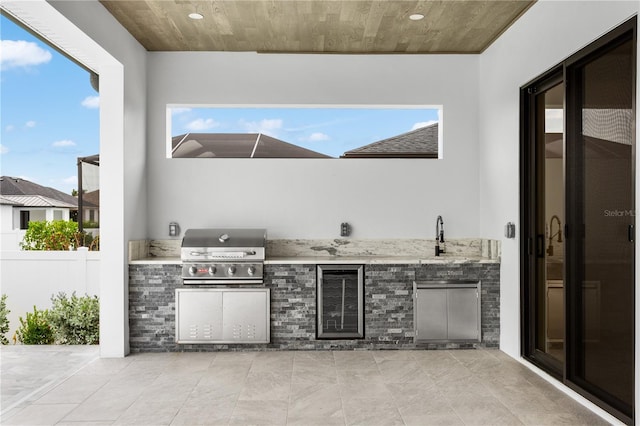 view of patio with exterior kitchen, sink, and grilling area