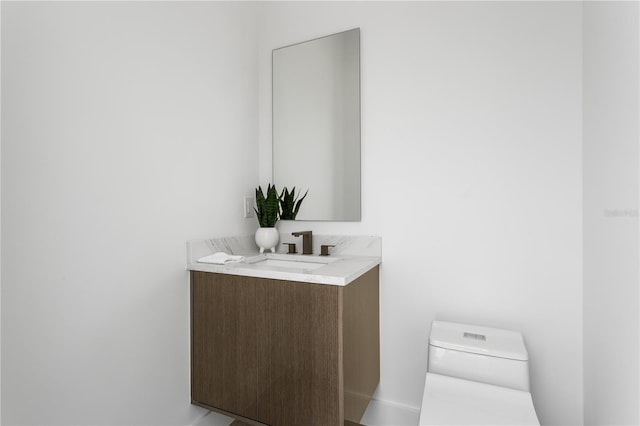 bathroom featuring toilet and vanity