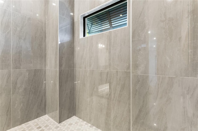 bathroom with tiled shower