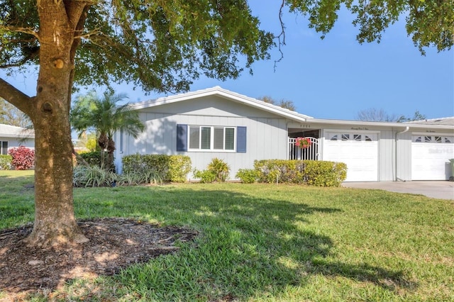 ranch-style house featuring a garage and a front lawn