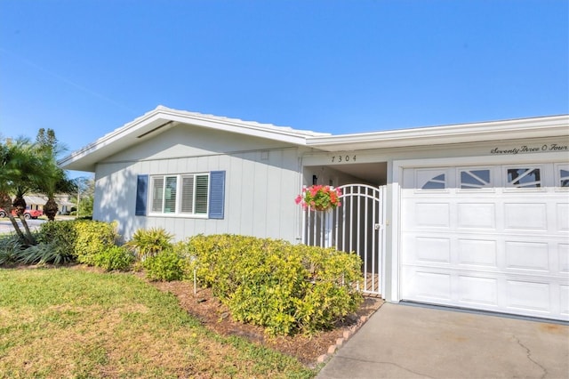 view of front facade featuring a garage and a gate