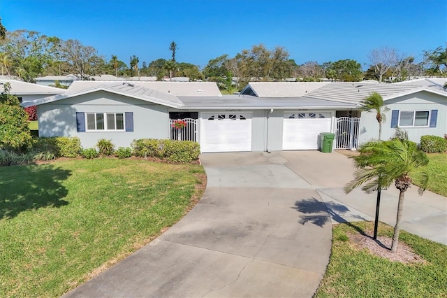 ranch-style home with a garage, concrete driveway, a front yard, and stucco siding