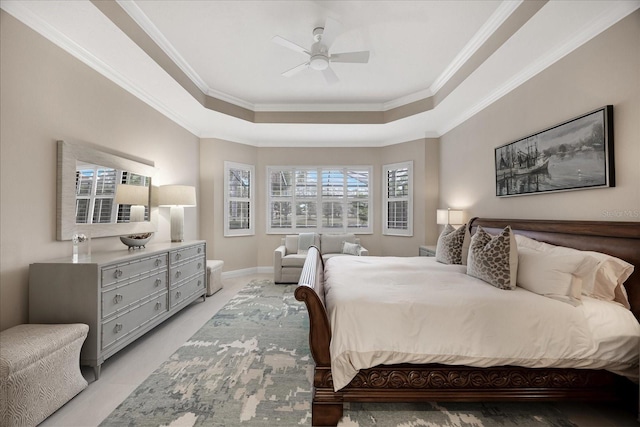 bedroom featuring ornamental molding, ceiling fan, and a raised ceiling