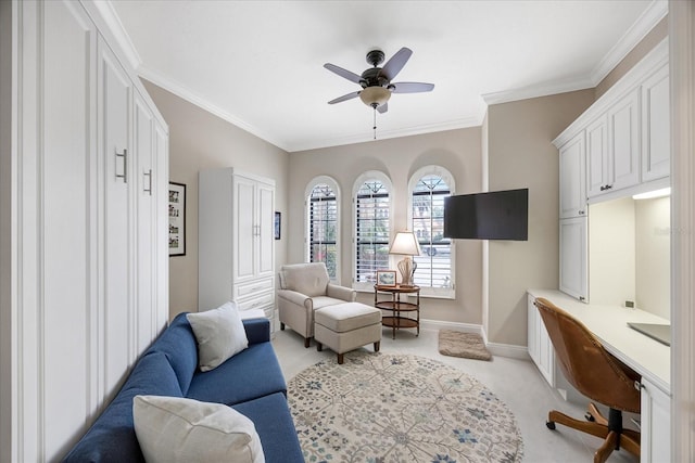 sitting room with ceiling fan, ornamental molding, and light carpet