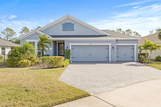 view of front of home featuring a front yard and a garage