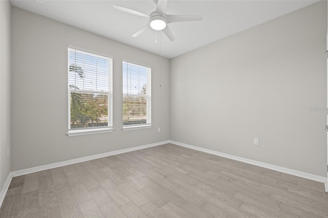 spare room with light wood-type flooring and ceiling fan