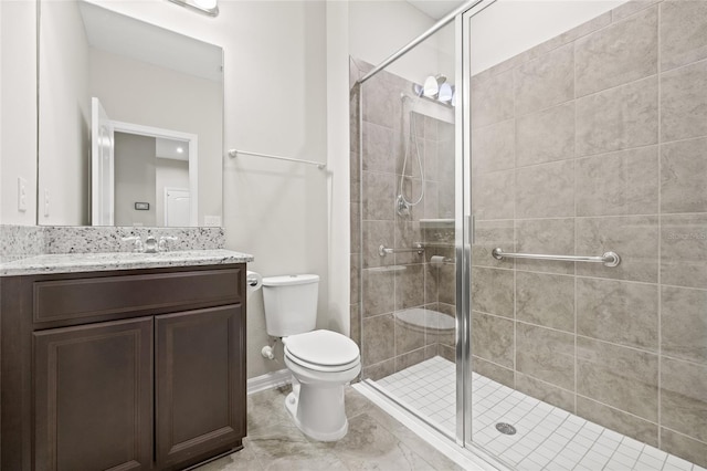 bathroom with toilet, a shower with door, and vanity