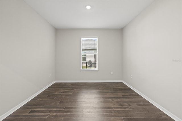 spare room with dark wood-type flooring