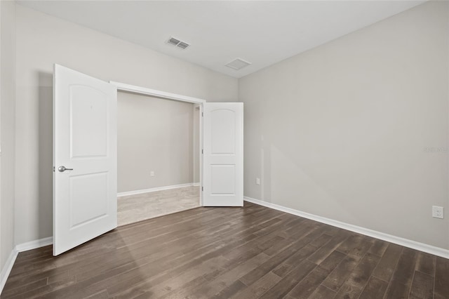 unfurnished bedroom with dark wood-type flooring