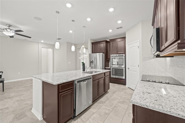 kitchen featuring a sink, a center island with sink, visible vents, a ceiling fan, and appliances with stainless steel finishes
