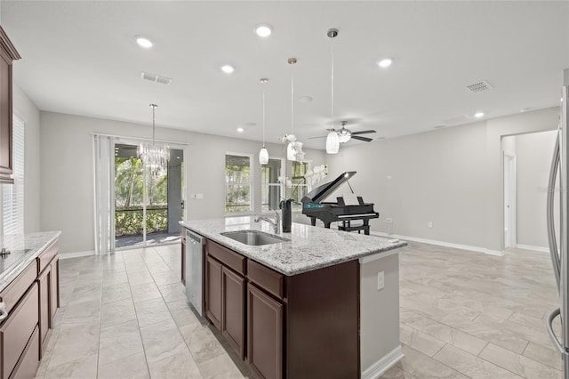 kitchen featuring visible vents, marble finish floor, a center island with sink, and a sink