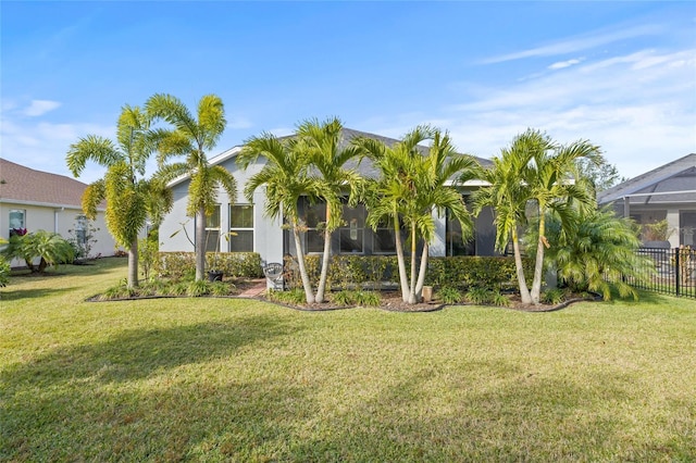 view of front of property with fence and a front lawn