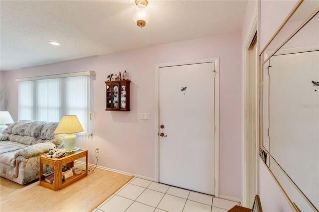 tiled entrance foyer with a textured ceiling