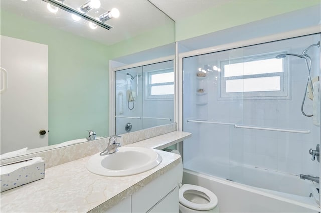 bathroom with vanity, a wealth of natural light, and shower / bath combination with glass door