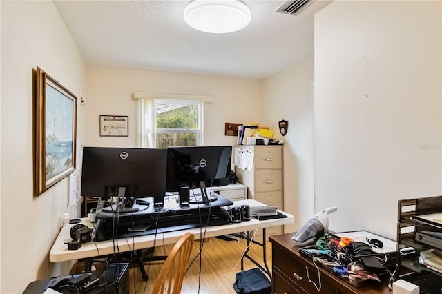 office area featuring a textured ceiling and wood-type flooring