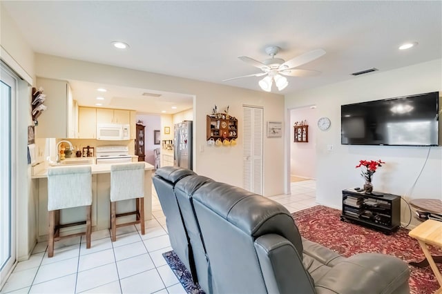 tiled living room featuring ceiling fan