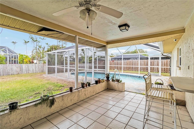 unfurnished sunroom featuring ceiling fan and plenty of natural light