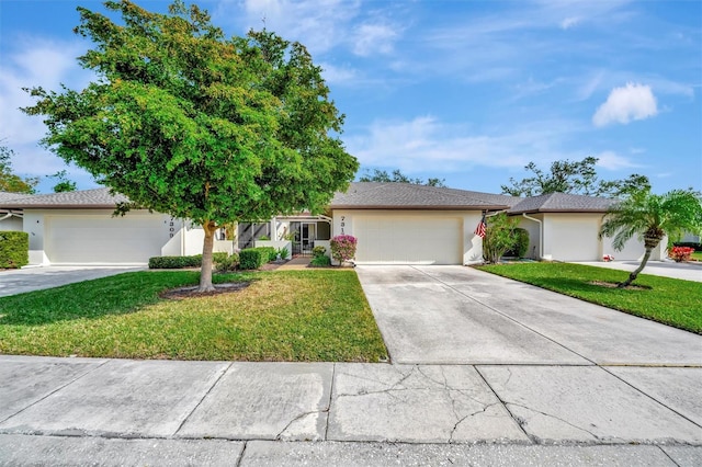 view of front of property with a garage and a front lawn