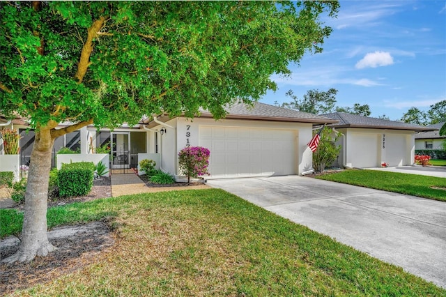 single story home featuring a garage and a front yard