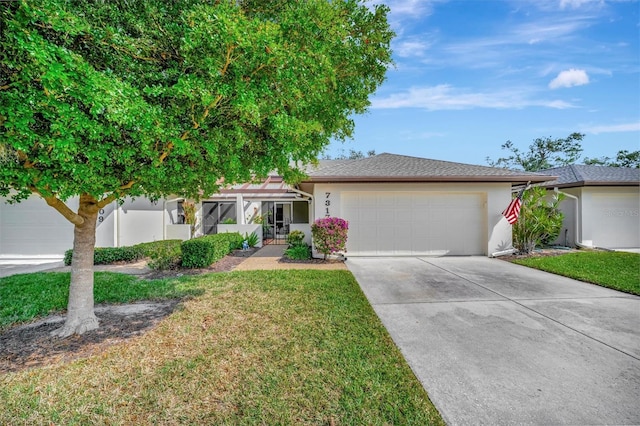 view of front of property featuring a front lawn and a garage