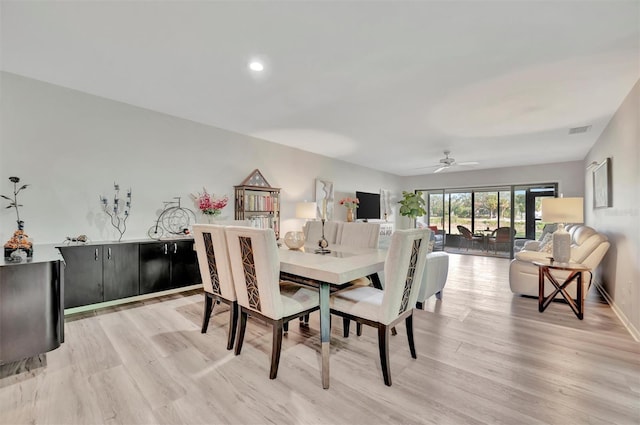 dining space featuring light wood-type flooring and ceiling fan