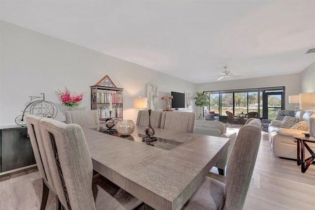 dining room with ceiling fan and light hardwood / wood-style floors