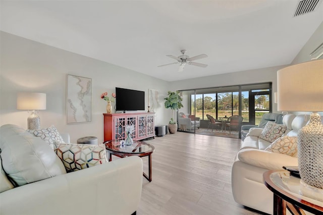 living room featuring light wood-type flooring and ceiling fan