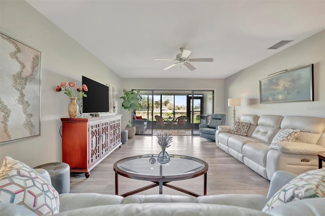 living room featuring ceiling fan and light hardwood / wood-style flooring