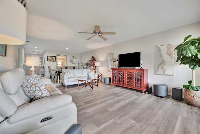 living room featuring ceiling fan and wood-type flooring