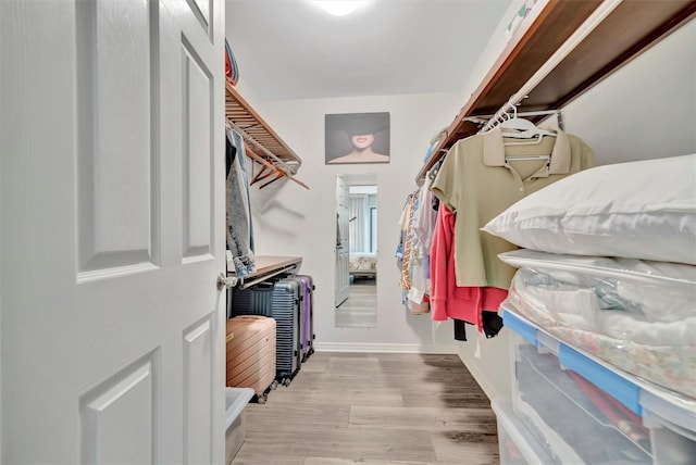 spacious closet with light hardwood / wood-style floors