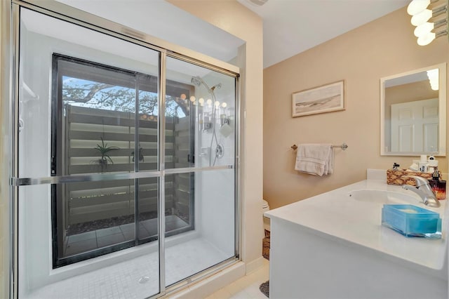 bathroom featuring an enclosed shower, vanity, and toilet