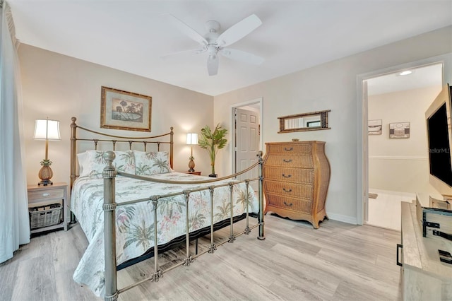 bedroom featuring ceiling fan, light wood-type flooring, and connected bathroom