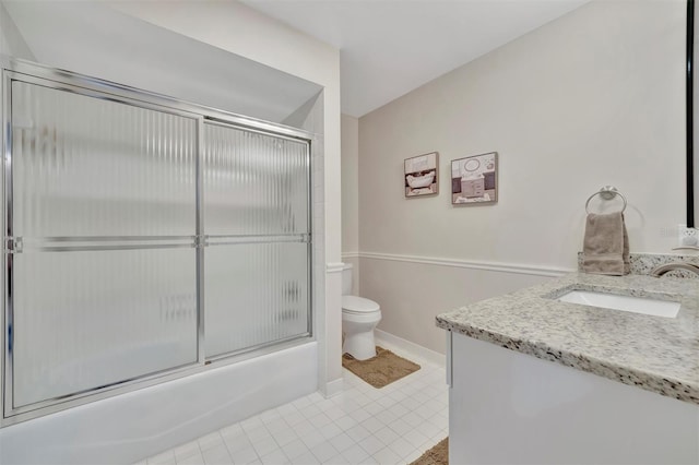 full bathroom featuring toilet, vanity, and shower / bath combination with glass door