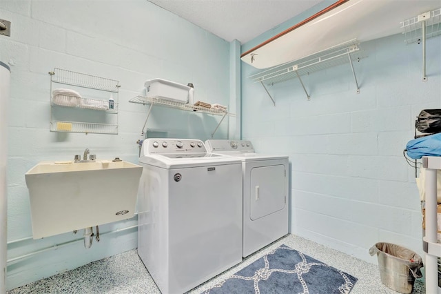 laundry room featuring washing machine and dryer and sink