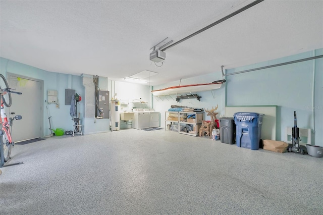 garage featuring water heater, a garage door opener, electric panel, and independent washer and dryer