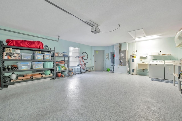 garage with a garage door opener, washer and dryer, electric water heater, and sink