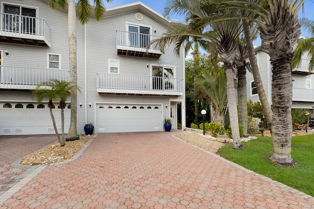 view of front of property with a balcony and a garage