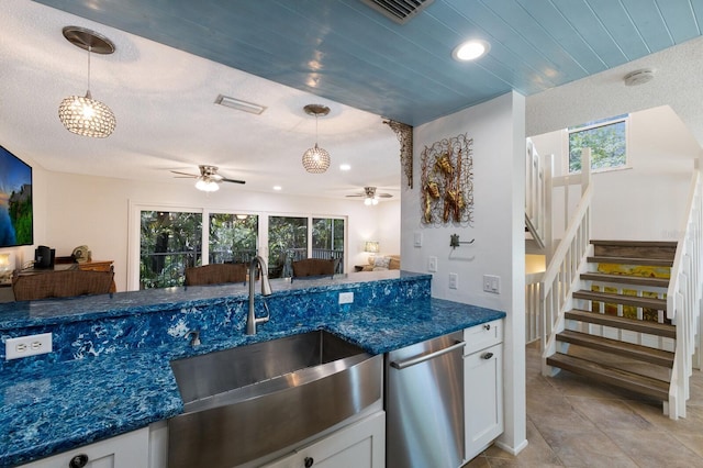 kitchen with dishwasher, hanging light fixtures, ceiling fan, sink, and white cabinetry