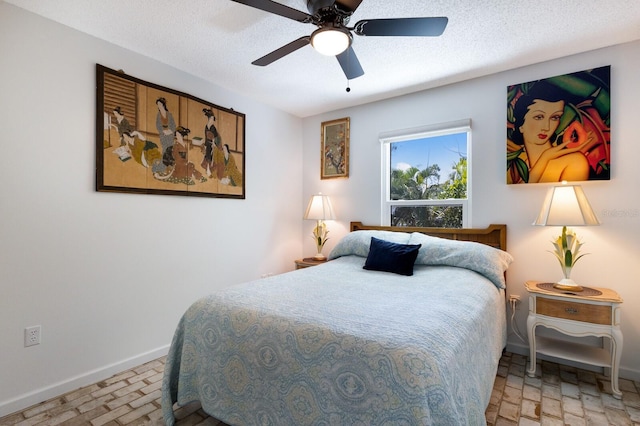 bedroom featuring a textured ceiling and ceiling fan