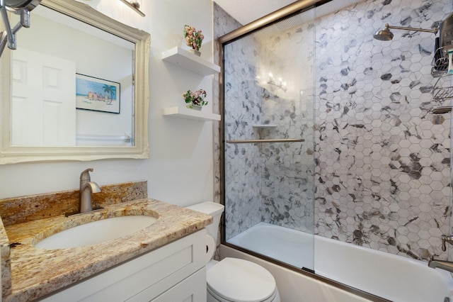 full bathroom with toilet, bath / shower combo with glass door, and vanity