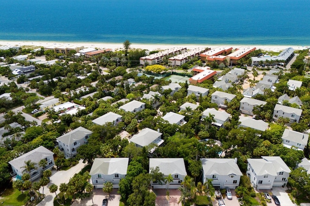 birds eye view of property featuring a water view and a view of the beach