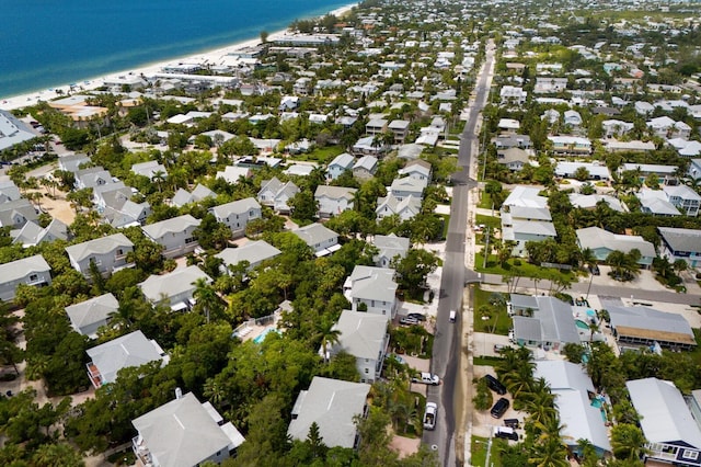 drone / aerial view featuring a beach view and a water view