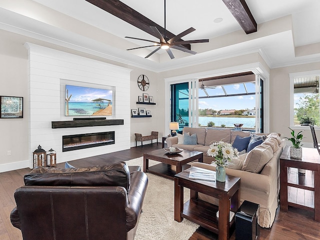 living room featuring ceiling fan, beam ceiling, dark hardwood / wood-style floors, crown molding, and a water view