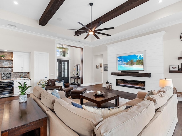 living room featuring wine cooler, dark wood-type flooring, beamed ceiling, and bar