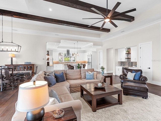 living room featuring ceiling fan, a tray ceiling, and hardwood / wood-style flooring