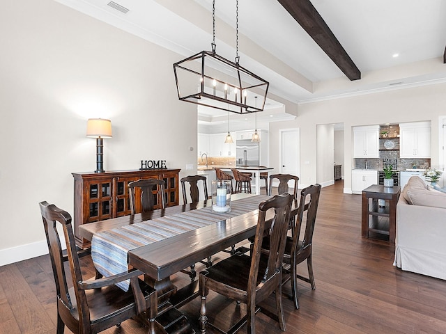 dining space with beamed ceiling, sink, dark hardwood / wood-style floors, a chandelier, and crown molding