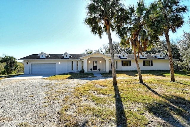 ranch-style home featuring a front yard and a garage