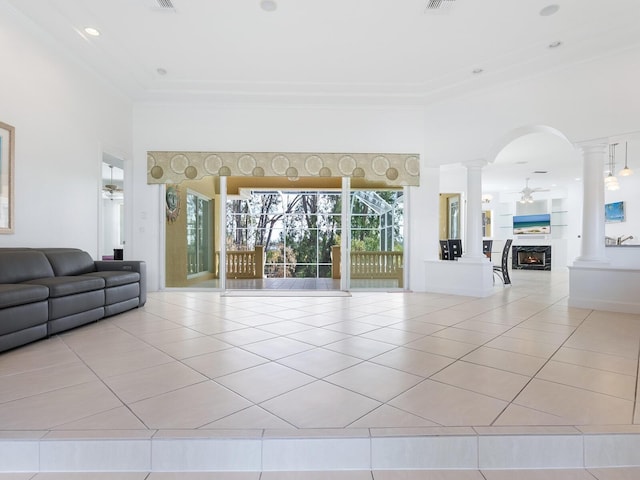 living room featuring ceiling fan, light tile patterned floors, and ornate columns