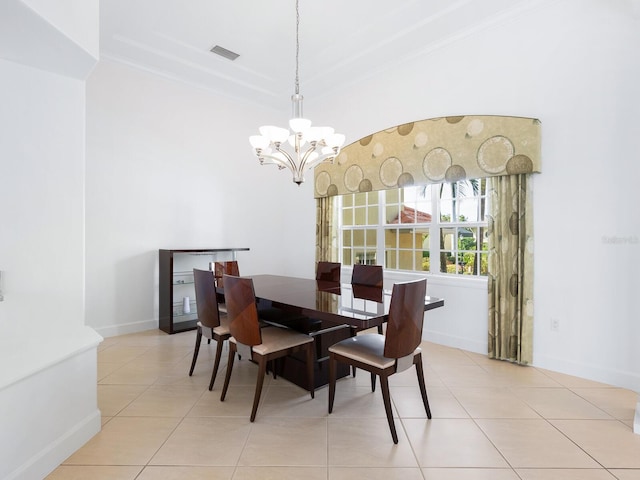 tiled dining room with a chandelier and crown molding