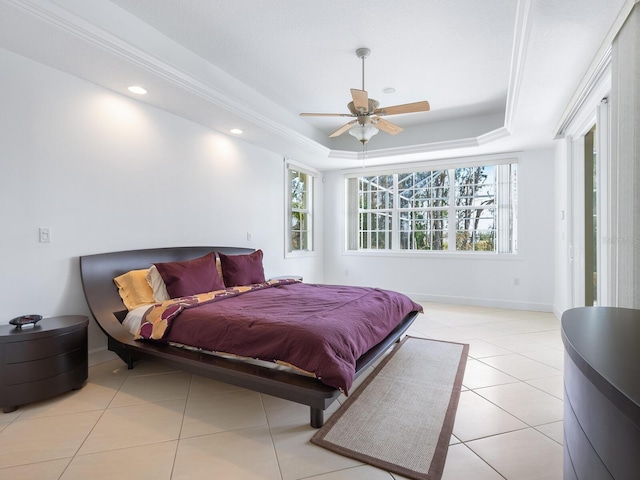 bedroom featuring ceiling fan, light tile patterned floors, a tray ceiling, and ornamental molding